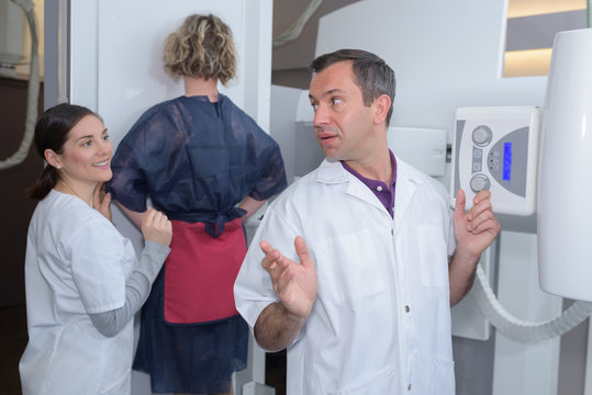 doctor and nurse joking while doing mammography