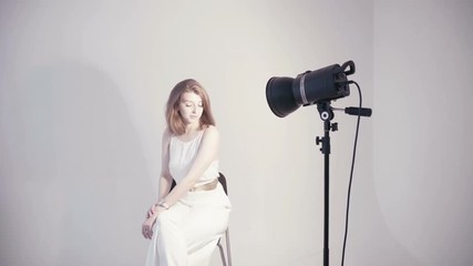 Photographer setting up studio lights for photo shoot