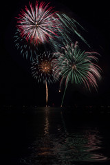 Colorful Fireworks with lake reflection