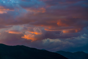 Sunset in the sky of Montenegro over the high mountains.