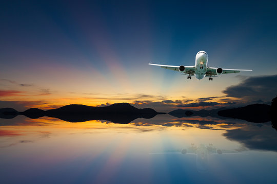 airplane in the sky with reflex beautiful sunset,concept open season tour and travel background. © panya99