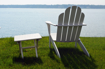 White Adirondack chair on grass pier 
