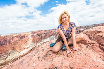 Upheaval dome crater in Canyonlands in Utah with woman sitting on edge