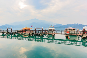 Fototapeta na wymiar Long exposure of harbor with boats in the morning time at Sun Moon Lake, Nantou city, Taiwan