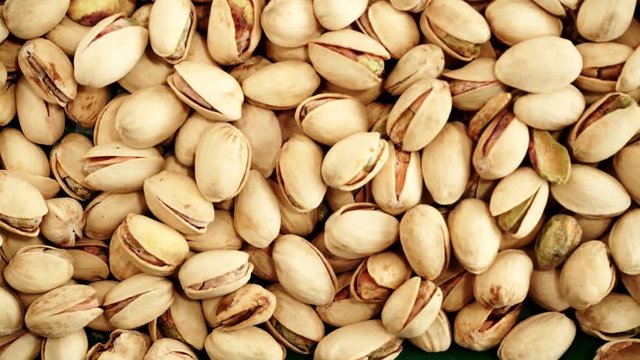 Food background. Roasted pistachio nuts seed with shell close up. Dieting concept. Dolly slider shot 4K ProRes HQ codec