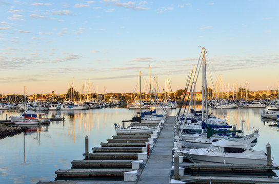 Many boats on marina during sunrise in Oxnard, California