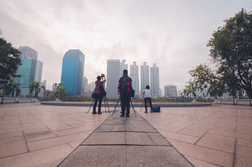 photographers shooting cityscape of high building in the city.