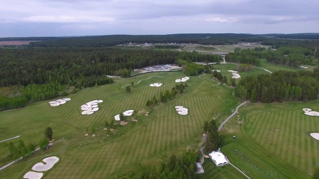 Top view green golf course outdoor green grass field. Aerial view from flying drone.