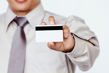 Businessman holding a credit card on white background