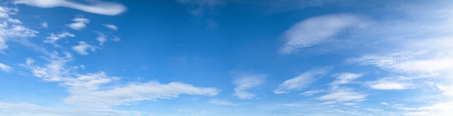 Panorama of blue sky background with white clouds on a sunny day