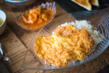  Sour soup made of tamarind paste with shrimp and fried omelet topped on rice