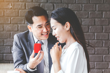 Man giving a ring for gift to a female