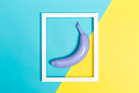Painted banana on a vibrant background with a picture frame
