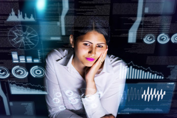 woman engineer looking at various information in screen of futuristic interface.