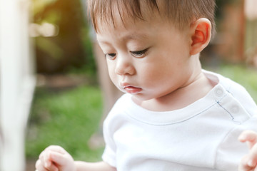 Asian baby boy look somewhere in the park