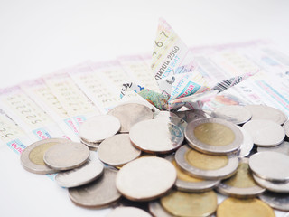 Coins and origami bird on Thai lottery