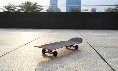 Afwasbaar fotobehang skateboard on city ready for next ride © lzf