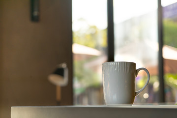 A mocha or cappuccino hot coffee in white cup on the wooden table