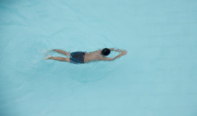 Top View A Boy Is Swimming In A Pool