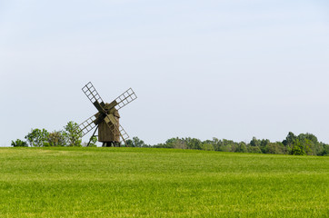 Fototapeta premium Old wooden windmill in a field