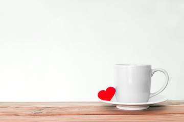 Coffee cup mug with red heart shape on wooden table , Romance and love valentines day background concept