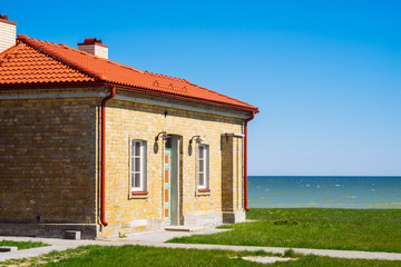 Brick house by the sea on sunny day