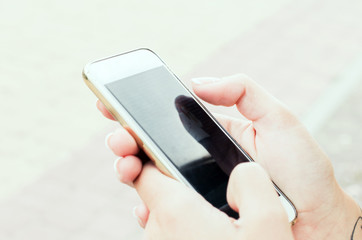 Close up of women's hands holding smartphone