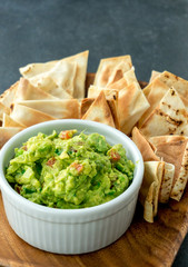 Guacamole vertical view. Guacamole is a avocado based dip, traditionally a mexican (Aztecs) dish. Healthy and easy to make at home with a few simple ingredients. Excellent as party food or at bars. © lounom