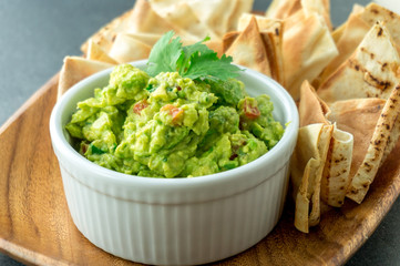 Fresh guacamole bowl. Guacamole is a avocado based dip, traditionally a mexican (Aztecs) dish. Healthy and easy to make at home with a few simple ingredients. Excellent as party food or at bars.