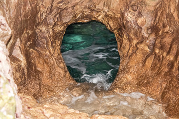 The grotto in the sea-rock during the summer day