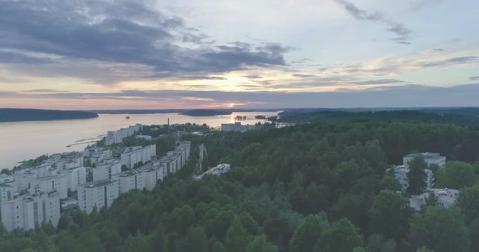 Evening aerial view of apartment houses by the lake in Lahti, Finland, sideways movement