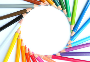 colored pencils row with wave on white background.