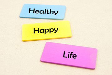 wooden tag with word healthy,happy and life concept isolated on yellow background
