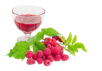 Raspberry jam in glass dessert bowl and fresh raspberries