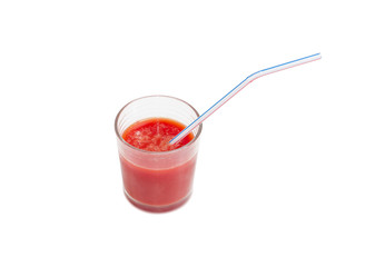 Glass of tomato juice with drinking straw