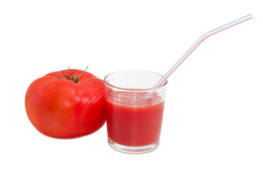 Tomato and glass of tomato juice with drinking straw