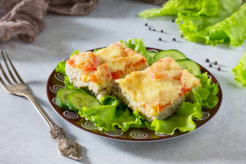 Сasserole zucchini with meat, rice, tomatoes and cheese on a gray stone background or slate.