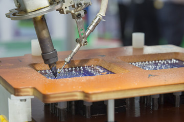 The robot welding machine welding the circuit print