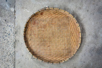 winnowing basket, bamboo threshing basket use for food airing on cement floor background