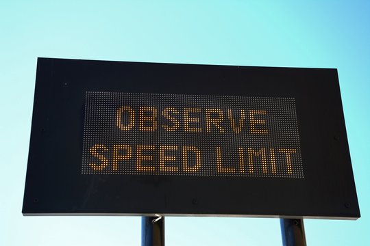 LED Observe speed limit sign with a black border against a blue sky, Valletta, Malta.
