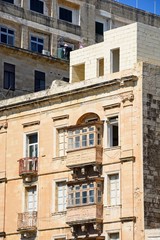 Traditional buildings with balconies in the city centre, Valletta, Malta.