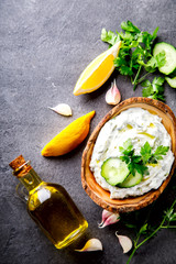 Tzatziki Traditional Greek sauce with ingredients cucumber, garlic, parsley, lemon, mint. Food Background.Snack, Meze in the dishes of the Olive Tree.Copy space for Text.selective focus.