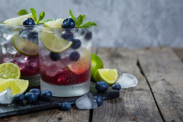 Blueberry mojito on rustic wood background