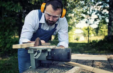 worker beard man with circular saw