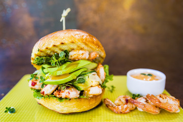 Delicious burger with shrimps and avocado. 