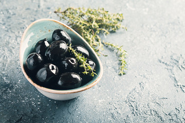 Bowl filled with fresh black olives