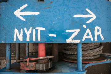 Nyit - Zár meaning Open - Close in Hungarian. Part of old, rustic machine.