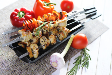 Kebab cooked on metal skewers with vegetables