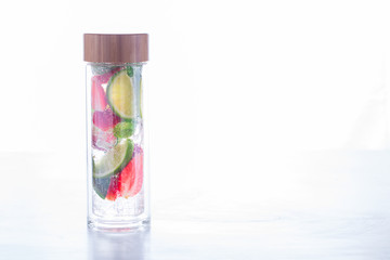 Drink with ice, berries, citrus and mint. Detox. Strawberry., lime. Mojito in a glass bottle.Food or Healthy diet concept.Super Food.Vegetarian.Copy space for Text.selective focus.