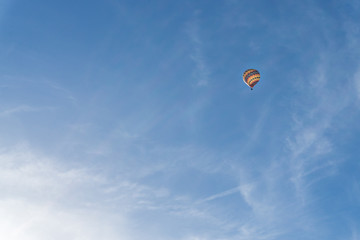 Colorful hot air balloon on bright blue sky